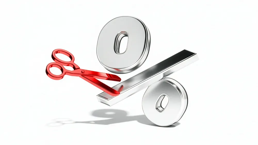 3D illustration of red scissors cutting through a large metallic percentage symbol, representing an interest rate cut or reduction in borrowing costs.