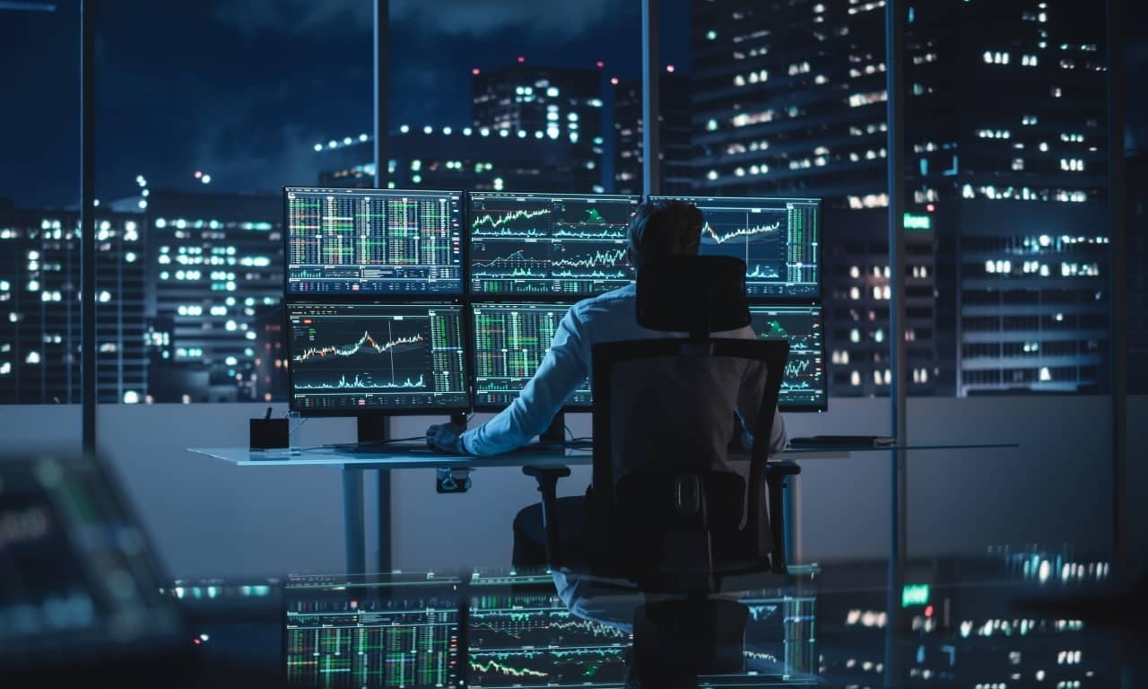 A forex trader looking at a forex trading platform on his computer